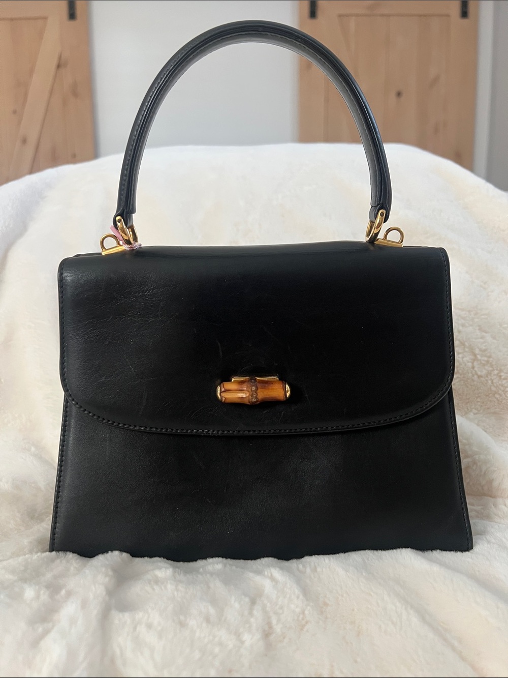 Gucci Black Leather Top-Handle Bag with Gold Accent and Bamboo Closure